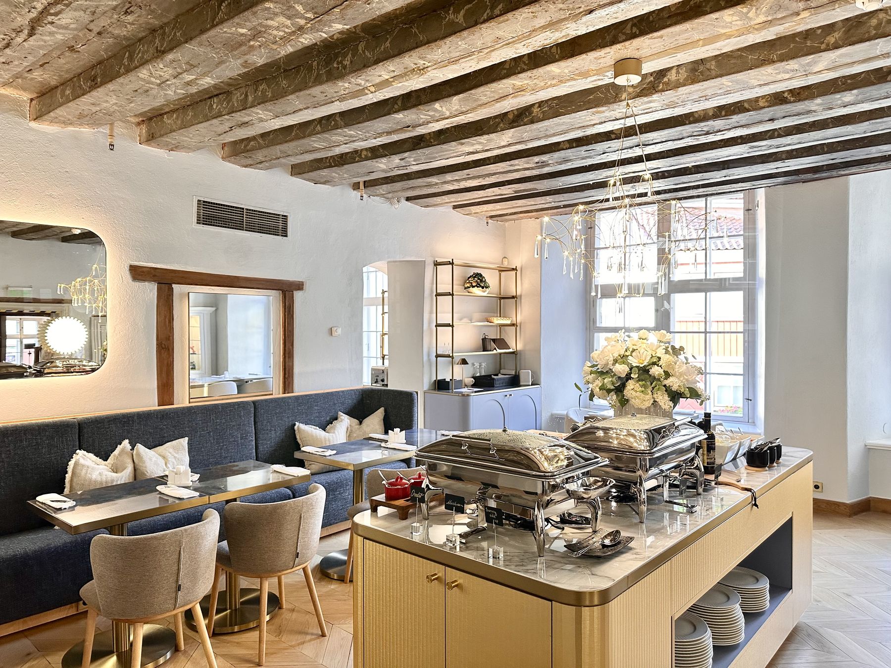 The breakfast room beneath the painted marble-beam ceiling